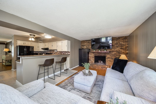 1747 Pleasant Ave, Saint Charles, IL 60174 - living room with a fireplace, a ceiling fan, and a textured ceiling