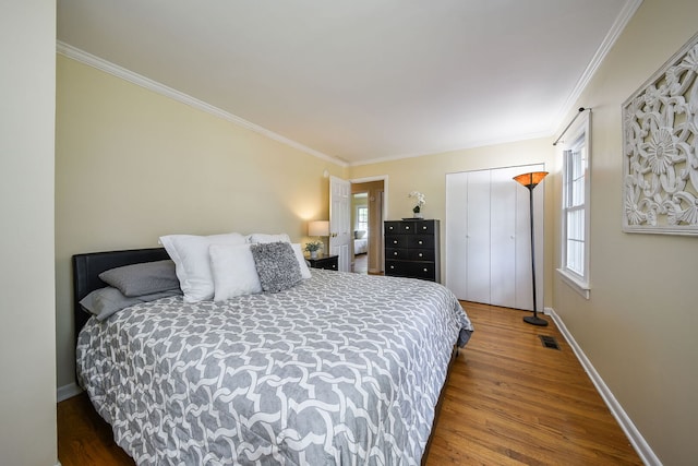 1747 Pleasant Ave, Saint Charles, IL 60174 - bedroom featuring multiple windows, crown molding, wood finished floors, and a closet