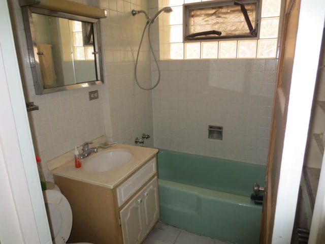 1642 W Olive Ave, Chicago, IL 60660 - bathroom featuring vanity, washtub / shower combination, tile walls, and tile patterned floors