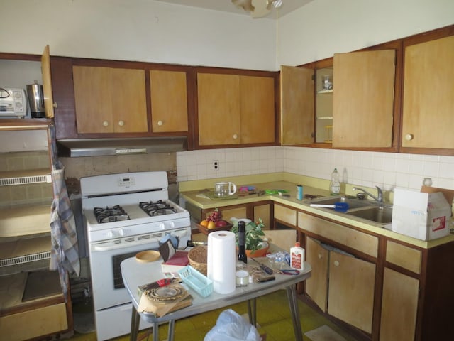 1642 W Olive Ave, Chicago, IL 60660 - kitchen with white gas stove, under cabinet range hood, decorative backsplash, and light countertops