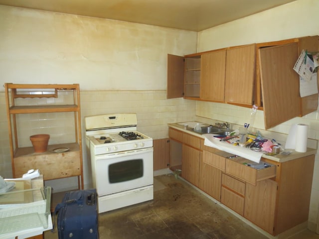 1642 W Olive Ave, Chicago, IL 60660 - kitchen featuring white gas stove, open shelves, light countertops, and tile walls