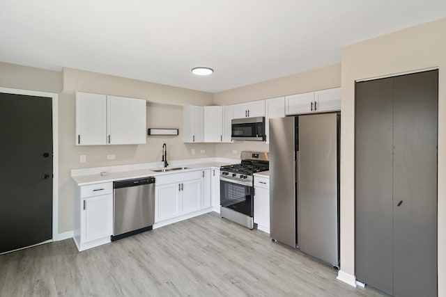 4117 186th Pl, Country Club Hills, IL 60478 - kitchen with appliances with stainless steel finishes, light wood-type flooring, light countertops, and white cabinetry