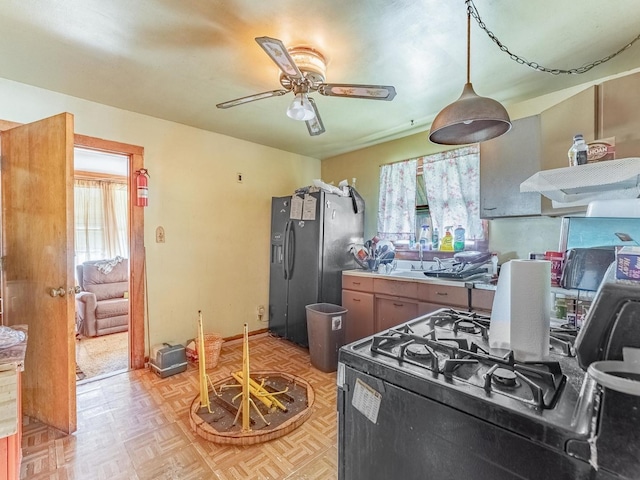 7959 S Coles Ave, Chicago, IL 60617 - kitchen with fridge with ice dispenser, black gas stove, and a ceiling fan