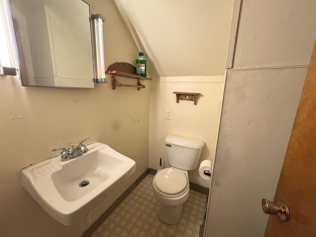 822 N 12th St, Rochelle, IL 61068 - bathroom featuring tile patterned floors and lofted ceiling