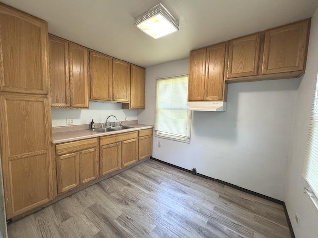 822 N 12th St, Rochelle, IL 61068 - kitchen featuring light countertops, light wood-style flooring, and brown cabinetry