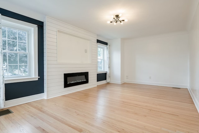 1833 Cuyler Ave, Berwyn, IL 60402 - unfurnished living room with light wood-type flooring, a chandelier, and a fireplace