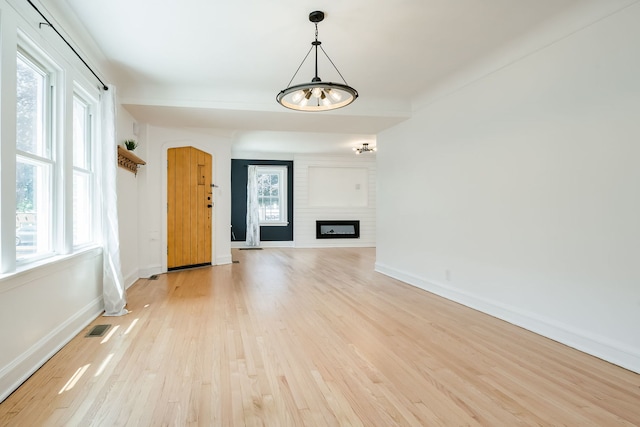 1833 Cuyler Ave, Berwyn, IL 60402 - unfurnished living room featuring light wood-style flooring and a fireplace