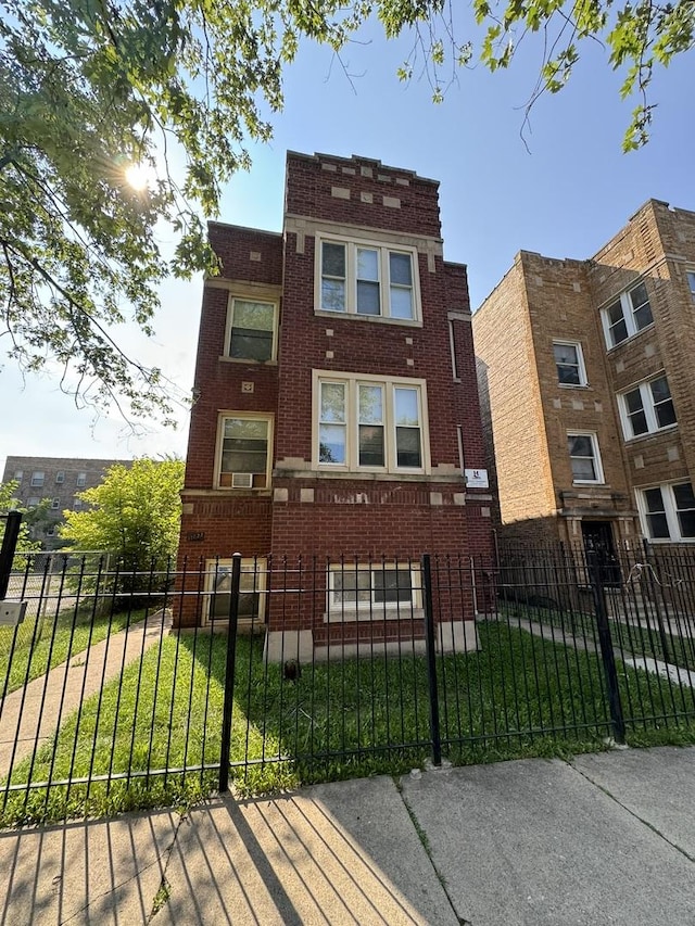11022 S Vernon Ave, Chicago, IL 60628 - front of property featuring brick siding and a fenced front yard
