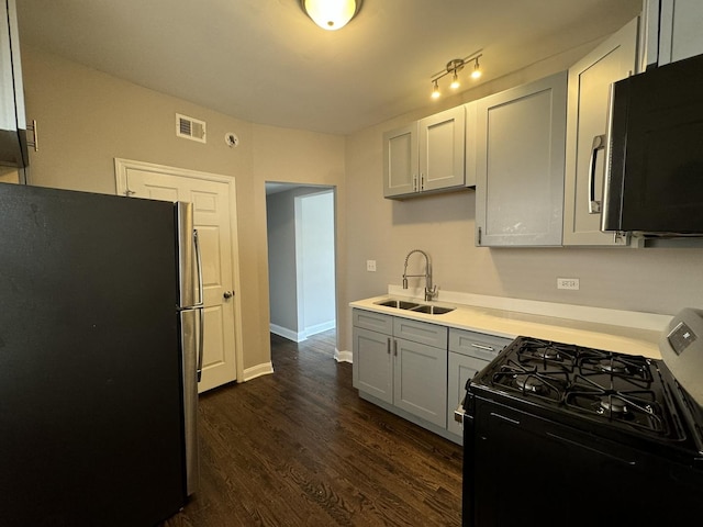 11022 S Vernon Ave, Chicago, IL 60628 - kitchen featuring freestanding refrigerator, black range with gas stovetop, dark wood-type flooring, and light countertops