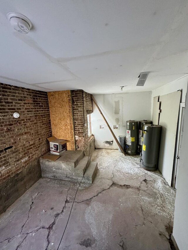 11022 S Vernon Ave, Chicago, IL 60628 - unfurnished living room with gas water heater and brick wall