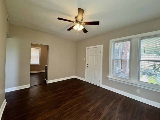 11022 S Vernon Ave, Chicago, IL 60628 - unfurnished room with dark wood-type flooring, plenty of natural light, and a ceiling fan