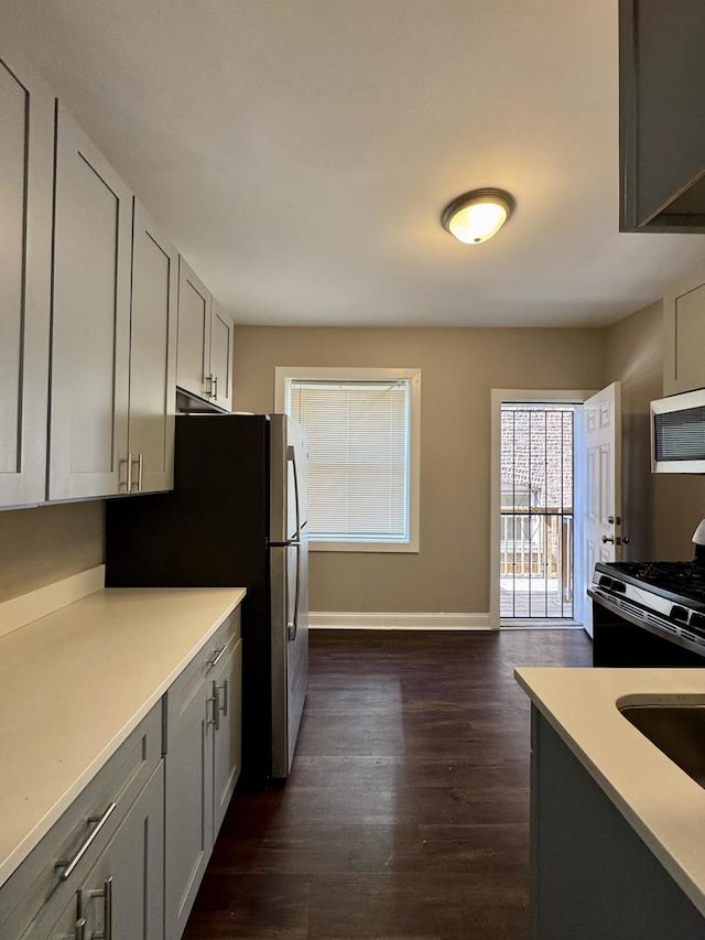 11022 S Vernon Ave, Chicago, IL 60628 - kitchen with stainless steel appliances, dark wood-type flooring, gray cabinets, and light countertops