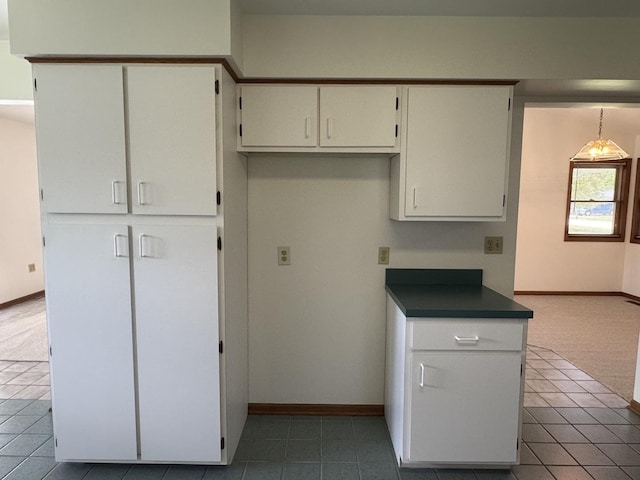 532 E 2nd St, Herscher, IL 60941 - kitchen with tile patterned flooring, white cabinets, and dark countertops