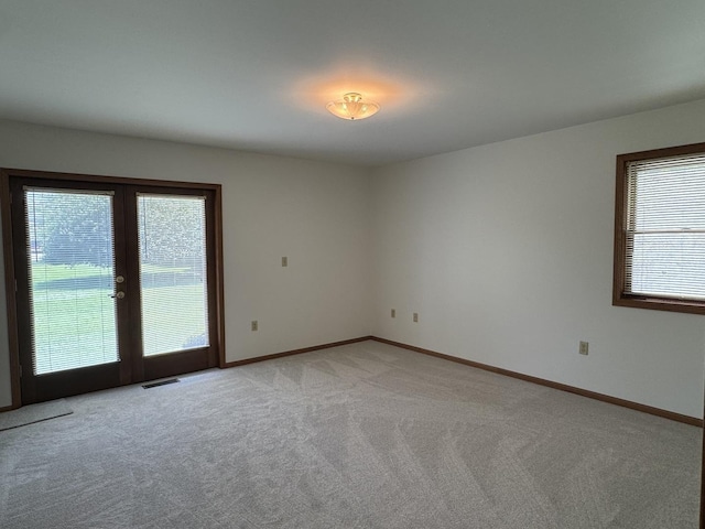 532 E 2nd St, Herscher, IL 60941 - unfurnished room with healthy amount of natural light, light carpet, and french doors