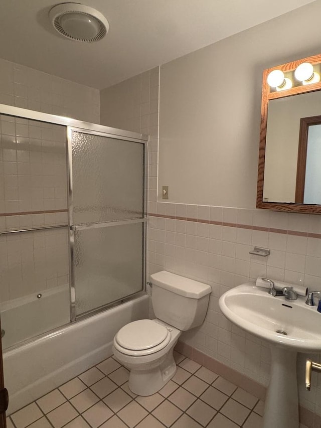 532 E 2nd St, Herscher, IL 60941 - full bath with shower / bath combination with glass door, tile patterned flooring, tile walls, and wainscoting