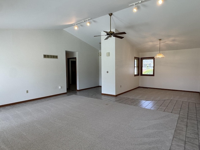 532 E 2nd St, Herscher, IL 60941 - spare room featuring rail lighting, lofted ceiling, a ceiling fan, tile patterned flooring, and carpet floors