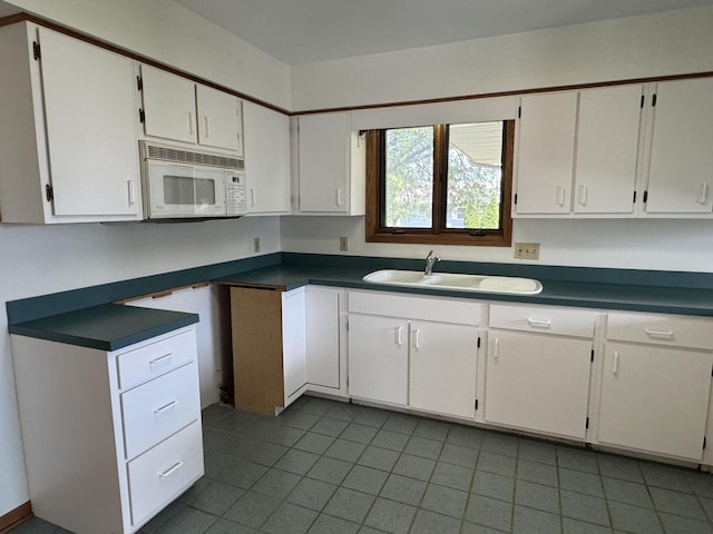532 E 2nd St, Herscher, IL 60941 - kitchen featuring white microwave, tile patterned floors, and white cabinets