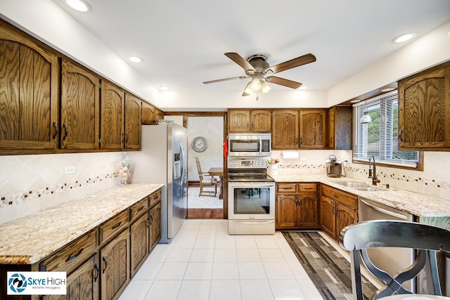 14463 S Canvasback Ct, Homer Glen, IL 60491 - kitchen with appliances with stainless steel finishes, a ceiling fan, and backsplash