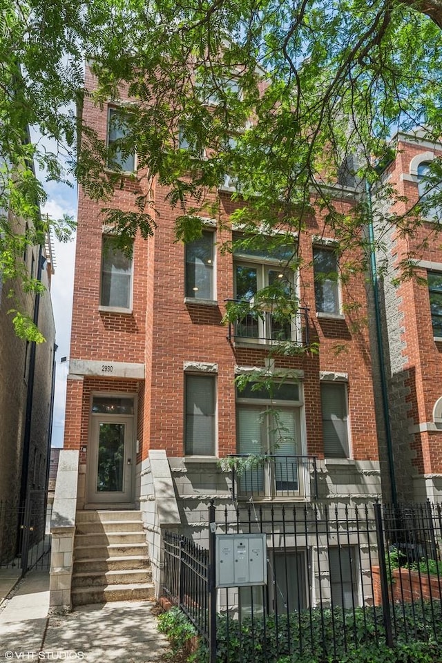 2930 N Damen Ave Unit 2, Chicago, IL 60618 - multi unit property featuring brick siding and a fenced front yard