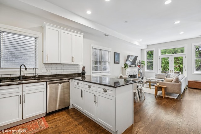 2930 N Damen Ave Unit 2, Chicago, IL 60618 - kitchen with dishwasher, a peninsula, dark wood finished floors, white cabinetry, and open floor plan