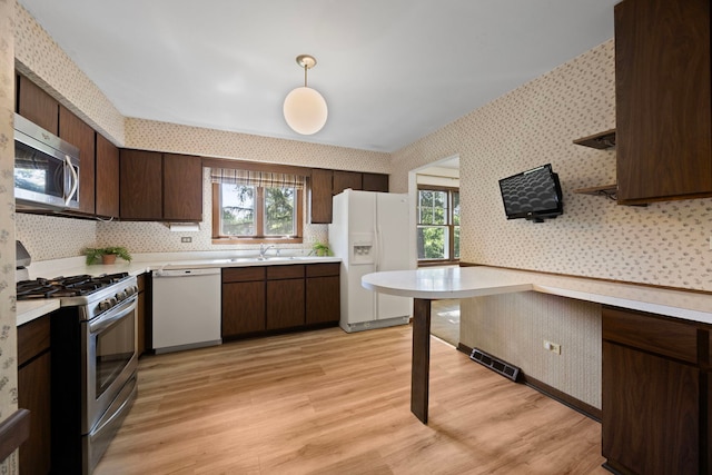 5245 Fairmount Ave, Downers Grove, IL 60515 - kitchen featuring stainless steel appliances, wallpapered walls, light countertops, and dark brown cabinets