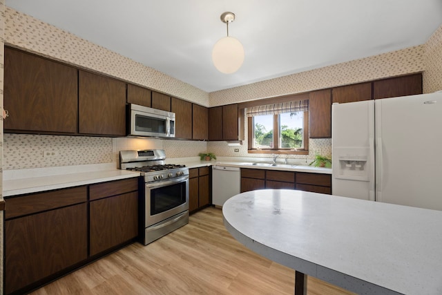 5245 Fairmount Ave, Downers Grove, IL 60515 - kitchen with stainless steel appliances, light countertops, light wood-type flooring, decorative backsplash, and dark brown cabinets