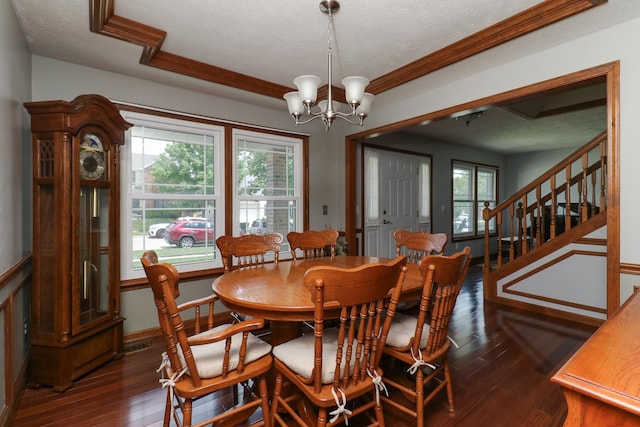 3003 Providence Dr, Bloomington, IL 61704 - dining space featuring dark wood-type flooring, a textured ceiling, a chandelier, stairs, and ornamental molding