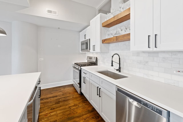 165 N Canal St Unit 1219, Chicago, IL 60606 - kitchen featuring stainless steel appliances, open shelves, backsplash, light countertops, and dark wood-style flooring