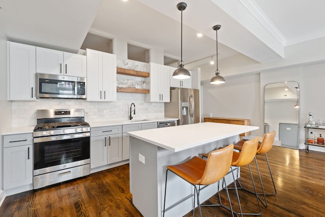 165 N Canal St Unit 1219, Chicago, IL 60606 - kitchen with stainless steel appliances, ornamental molding, a center island, open shelves, and a kitchen bar