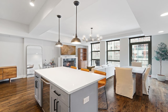 165 N Canal St Unit 1219, Chicago, IL 60606 - kitchen featuring beverage cooler, a center island, dark wood finished floors, gray cabinets, and light countertops