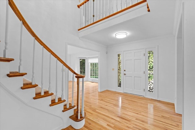 1280 Lawrence Ave, Lake Forest, IL 60045 - foyer with wood finished floors, stairway, crown molding, and a high ceiling