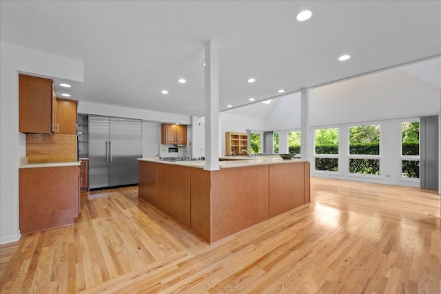 1280 Lawrence Ave, Lake Forest, IL 60045 - kitchen featuring light wood finished floors, light countertops, recessed lighting, brown cabinets, and open floor plan
