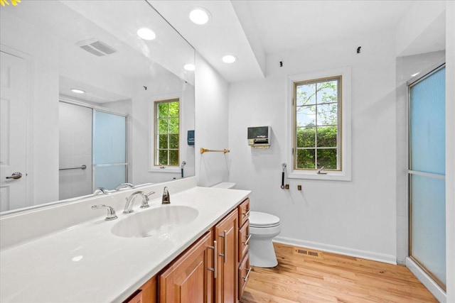 1280 Lawrence Ave, Lake Forest, IL 60045 - bathroom with healthy amount of natural light, vanity, a shower with shower door, wood finished floors, and recessed lighting