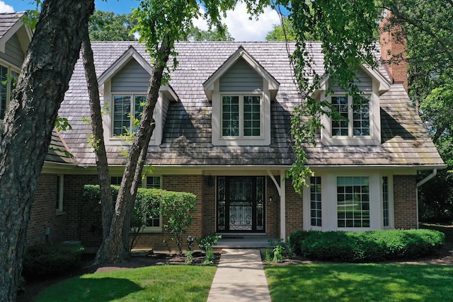 1280 Lawrence Ave, Lake Forest, IL 60045 - view of front of property with brick siding, a front lawn, and a chimney