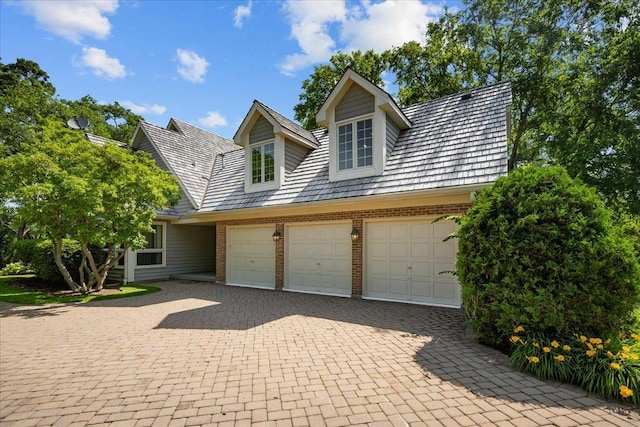 1280 Lawrence Ave, Lake Forest, IL 60045 - view of front of property with brick siding, decorative driveway, and an attached garage