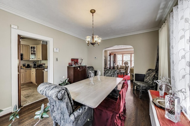 1003 Mapleton Ave, Oak Park, IL 60302 - dining room with arched walkways, ornamental molding, dark wood-type flooring, and a chandelier