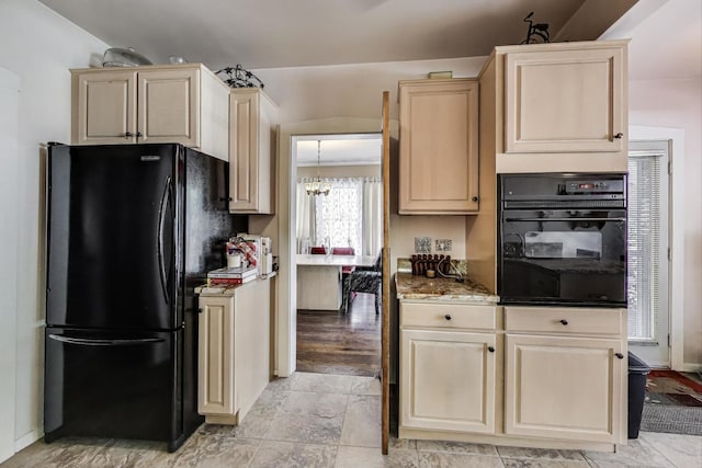 1003 Mapleton Ave, Oak Park, IL 60302 - kitchen with black appliances, light brown cabinets, a chandelier, light stone countertops, and cream cabinets