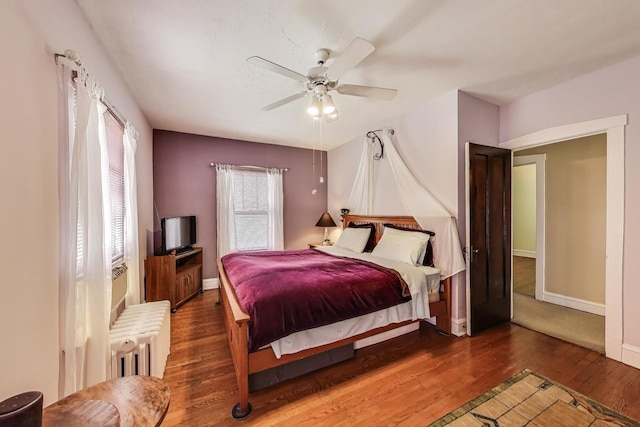 1003 Mapleton Ave, Oak Park, IL 60302 - bedroom with radiator heating unit, wood finished floors, and ceiling fan