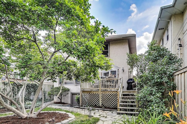 1003 Mapleton Ave, Oak Park, IL 60302 - back of property with stucco siding, a wooden deck, and stairs
