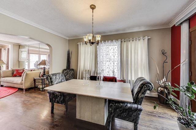 1003 Mapleton Ave, Oak Park, IL 60302 - dining space with wood finished floors, crown molding, a chandelier, and arched walkways