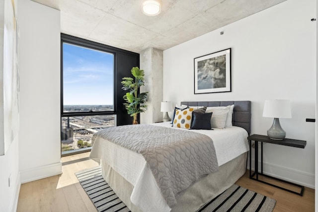 234 W Polk St Unit 3403, Chicago, IL 60607 - bedroom featuring multiple windows, wood finished floors, and floor to ceiling windows