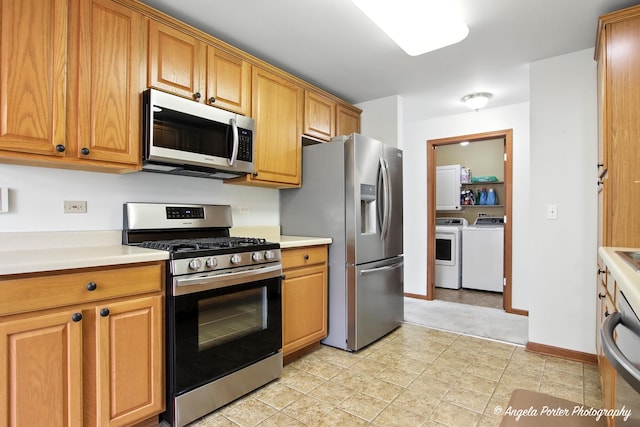 312 Whitaker Trl Unit 312, Mchenry, IL 60050 - kitchen with appliances with stainless steel finishes, separate washer and dryer, light countertops, and brown cabinets