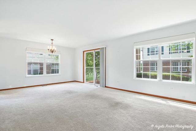 312 Whitaker Trl Unit 312, Mchenry, IL 60050 - spare room featuring healthy amount of natural light, a chandelier, and carpet floors