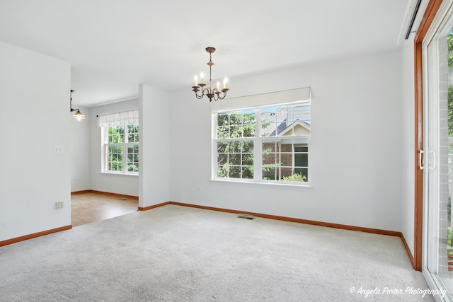 312 Whitaker Trl Unit 312, Mchenry, IL 60050 - empty room with carpet and a chandelier