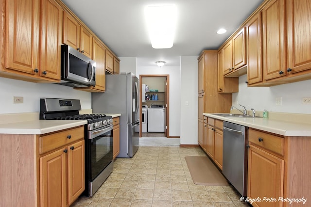 312 Whitaker Trl Unit 312, Mchenry, IL 60050 - kitchen with appliances with stainless steel finishes, washing machine and clothes dryer, light countertops, and recessed lighting