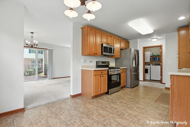 312 Whitaker Trl Unit 312, Mchenry, IL 60050 - kitchen featuring appliances with stainless steel finishes, a chandelier, independent washer and dryer, light carpet, and light countertops