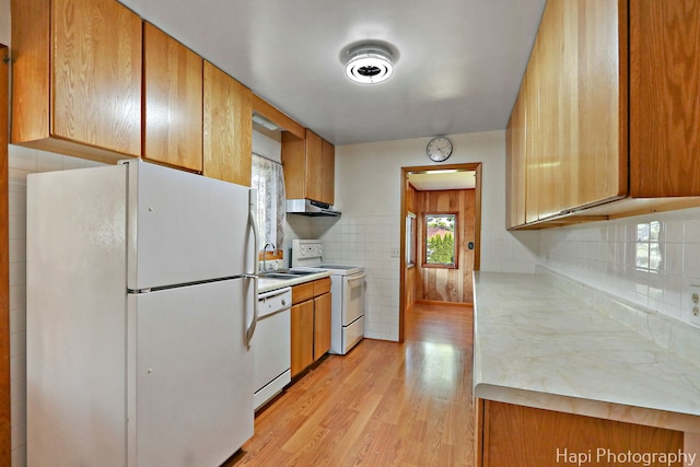 34719 N Nokomis Trl, Mchenry, IL 60051 - kitchen featuring white appliances, light countertops, light wood-type flooring, brown cabinetry, and under cabinet range hood