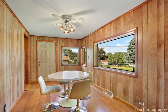 34719 N Nokomis Trl, Mchenry, IL 60051 - dining room with light wood-type flooring, wooden walls, and ceiling fan