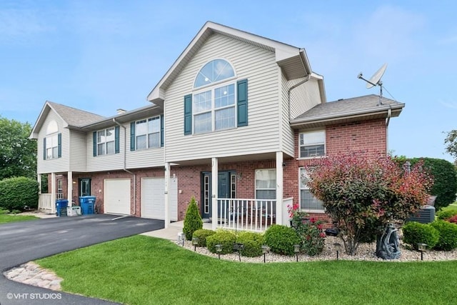 3749 W Glen Dr Unit 1001, Alsip, IL 60803 - townhome / multi-family property with a porch, brick siding, driveway, a front lawn, and a garage