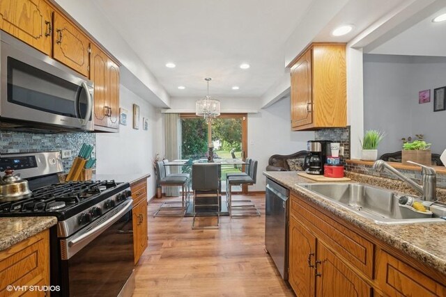 3749 W Glen Dr Unit 1001, Alsip, IL 60803 - kitchen with stainless steel appliances, light wood-style floors, a chandelier, backsplash, and recessed lighting